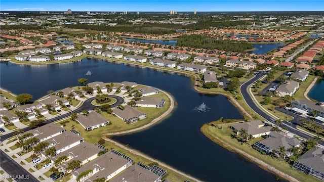 birds eye view of property with a water view and a residential view