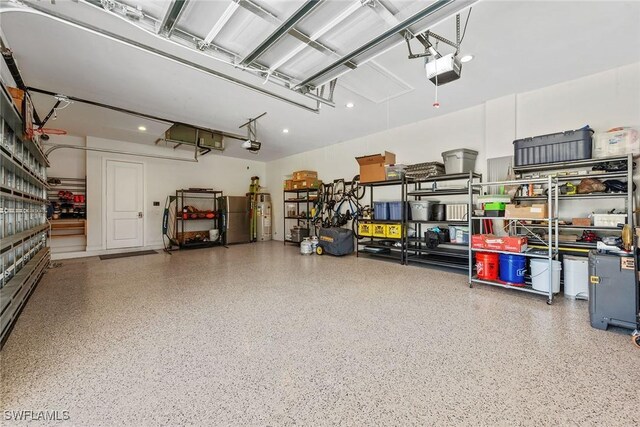 garage featuring a garage door opener and freestanding refrigerator