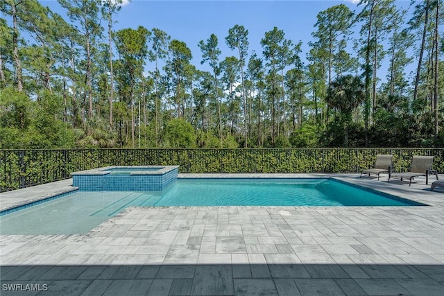 view of pool featuring a pool with connected hot tub and a patio