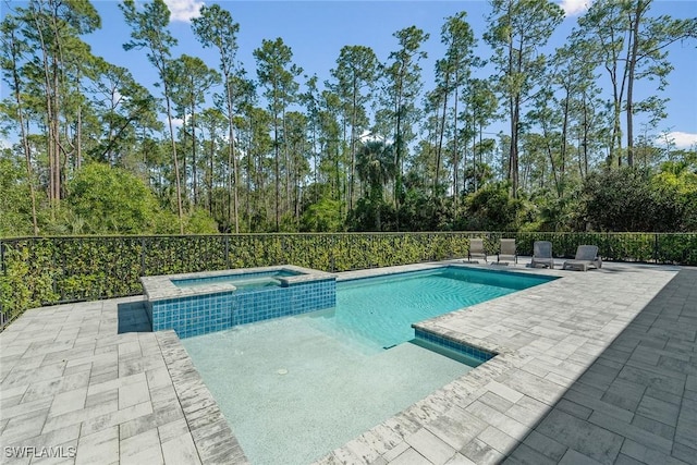 view of swimming pool featuring a patio area and a pool with connected hot tub