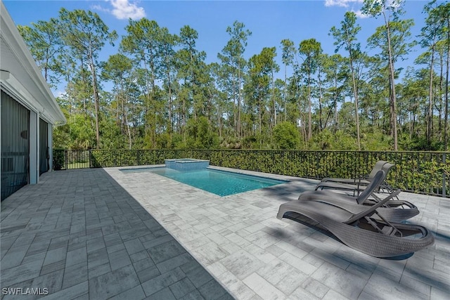 view of pool with a pool with connected hot tub and a patio area