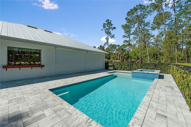 view of swimming pool with a pool with connected hot tub and a patio