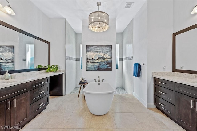 full bath with vanity, visible vents, a freestanding bath, tile patterned flooring, and walk in shower