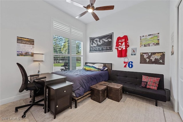 bedroom featuring ceiling fan and baseboards