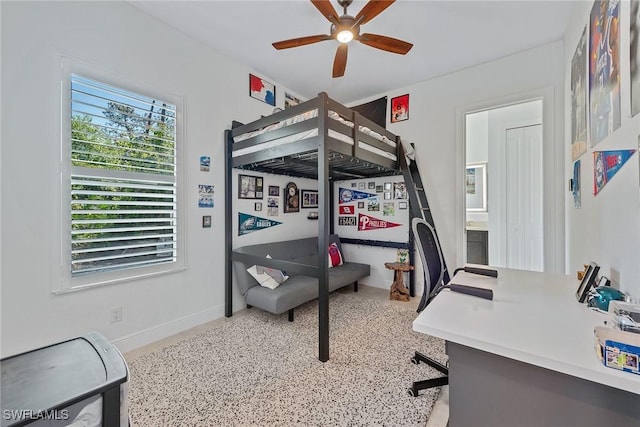 bedroom with ceiling fan and baseboards