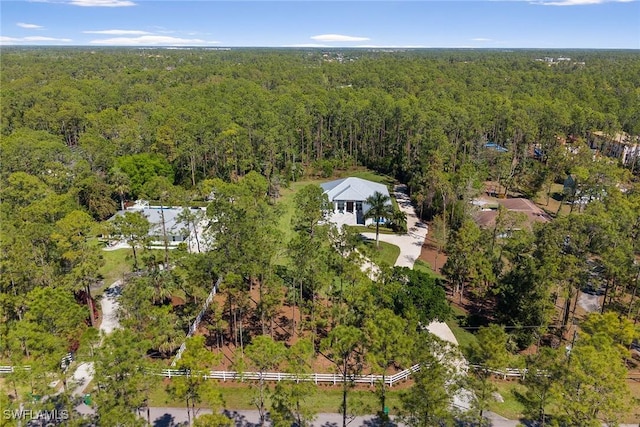 drone / aerial view featuring a forest view