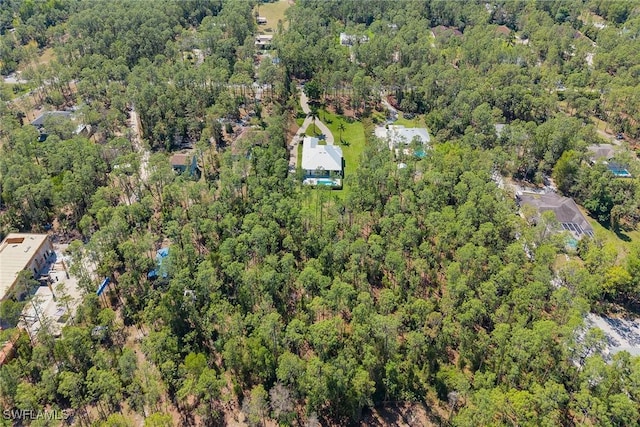 birds eye view of property with a forest view