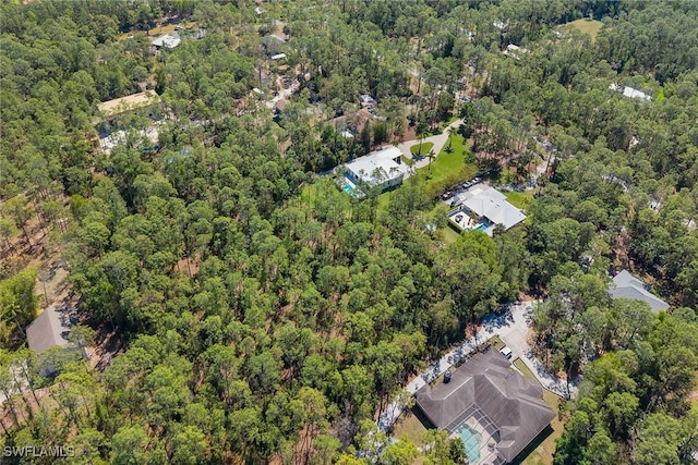 birds eye view of property with a view of trees