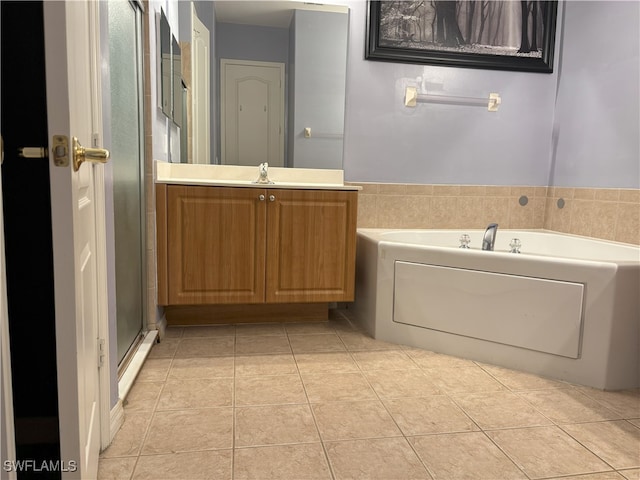 full bath with a bath, tile patterned flooring, a stall shower, and vanity