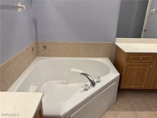 full bathroom with tile patterned flooring, vanity, and a garden tub