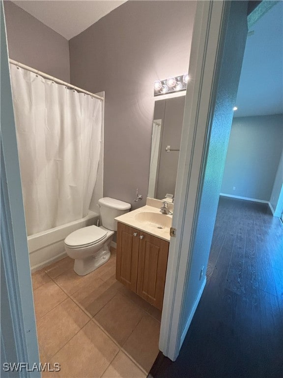 full bath featuring vanity, toilet, wood finished floors, and shower / bath combo with shower curtain