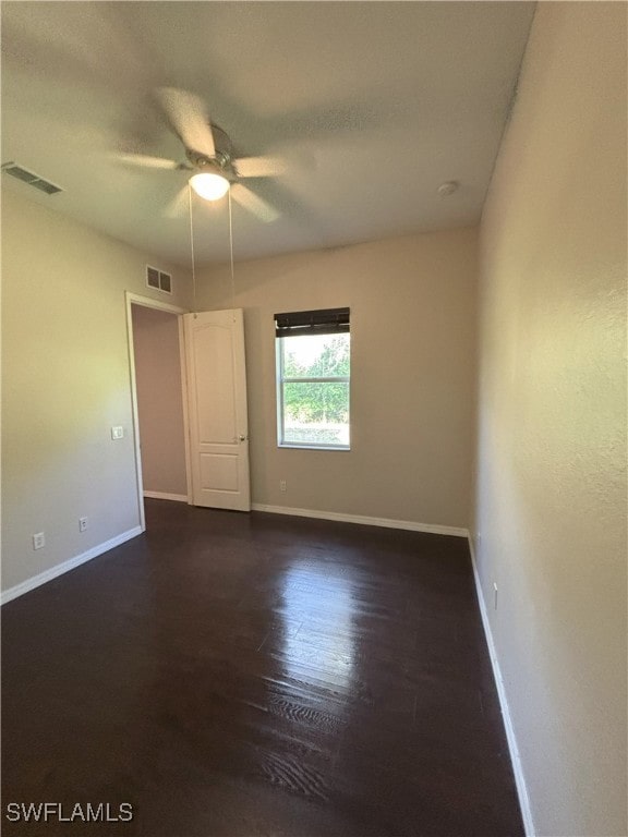 unfurnished room with baseboards, visible vents, and ceiling fan