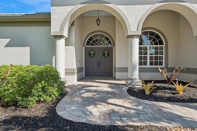 property entrance with stucco siding