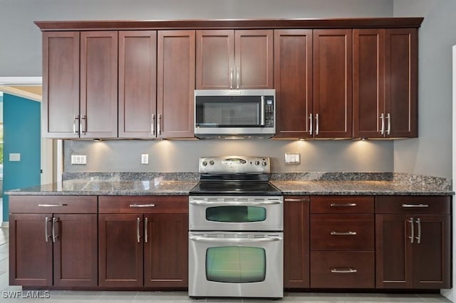 kitchen with dark stone countertops and appliances with stainless steel finishes