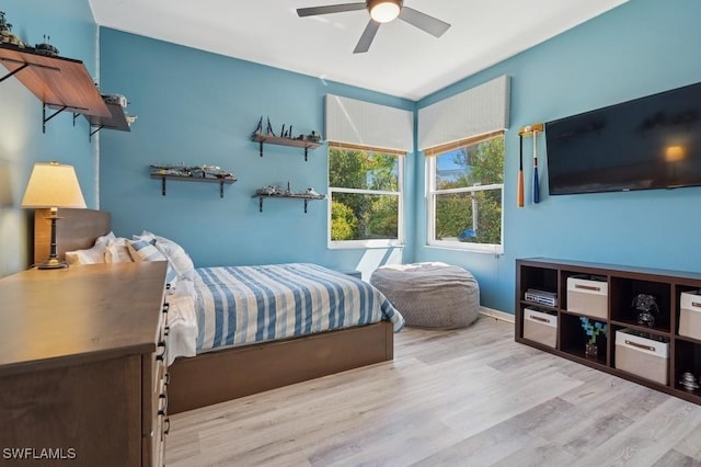 bedroom with baseboards, a ceiling fan, and wood finished floors