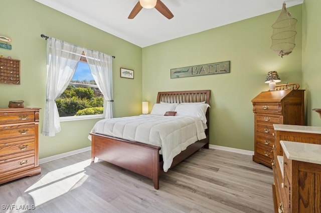 bedroom with light wood finished floors, ceiling fan, and baseboards