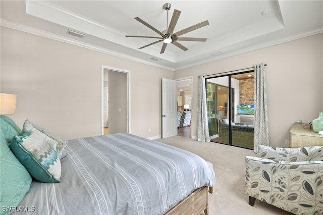 carpeted bedroom with a tray ceiling, access to exterior, and visible vents