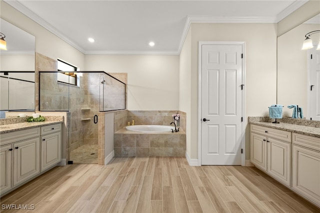 full bath featuring crown molding, a bath, a stall shower, and wood finish floors