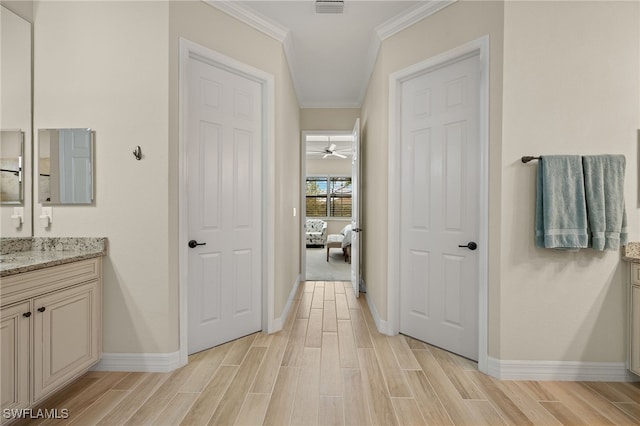 bathroom with vanity, a ceiling fan, baseboards, wood finish floors, and crown molding