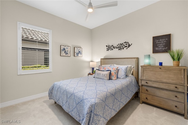 carpeted bedroom featuring a ceiling fan and baseboards