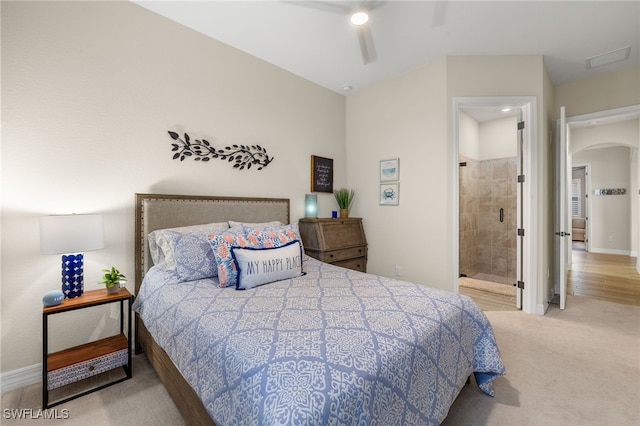 bedroom with ensuite bath, arched walkways, carpet, baseboards, and ceiling fan