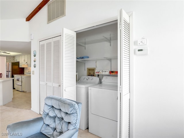 washroom with washer and dryer, laundry area, and visible vents