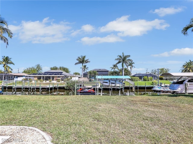 view of dock with a yard, a residential view, and a water view