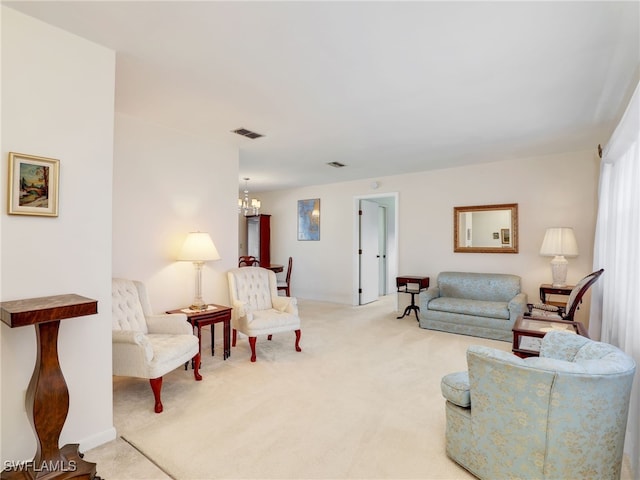 carpeted living area with a chandelier and visible vents