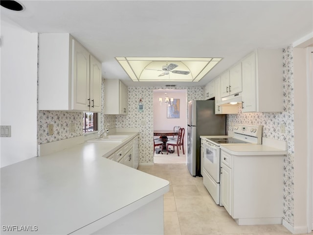 kitchen featuring wallpapered walls, an inviting chandelier, electric range, a sink, and light countertops