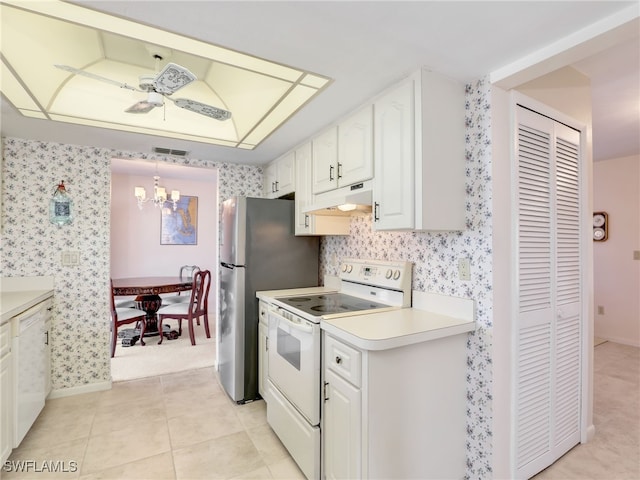 kitchen with wallpapered walls, a chandelier, under cabinet range hood, white range with electric stovetop, and white cabinets