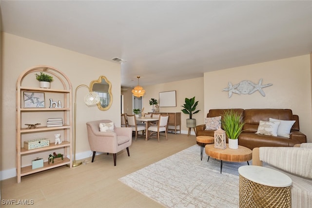 living room featuring visible vents and baseboards