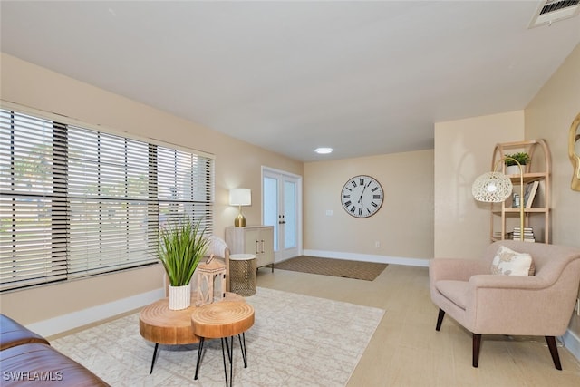 living area featuring visible vents and baseboards