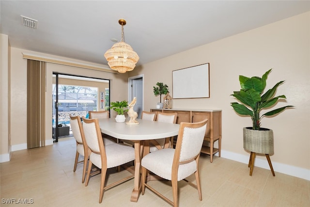 dining area with visible vents, baseboards, and a notable chandelier