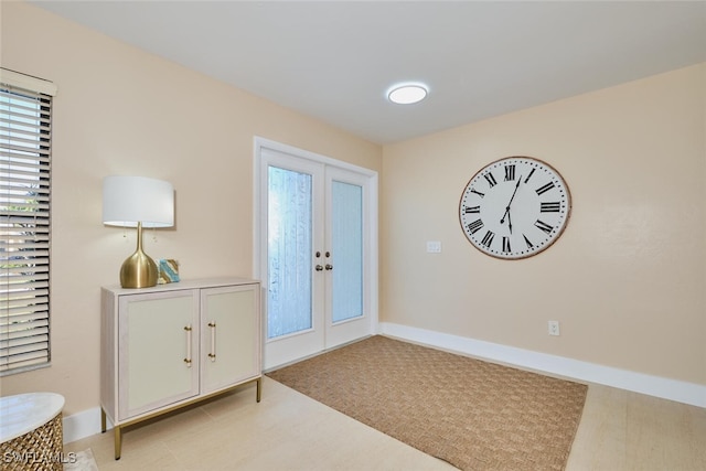 foyer featuring french doors and baseboards