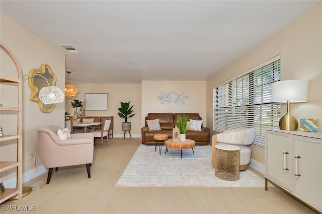 living area with visible vents and baseboards