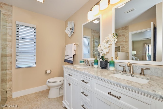 full bath with toilet, baseboards, visible vents, and a sink