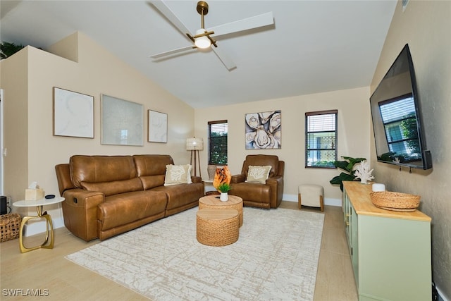 living area with lofted ceiling, a ceiling fan, light wood-type flooring, and baseboards