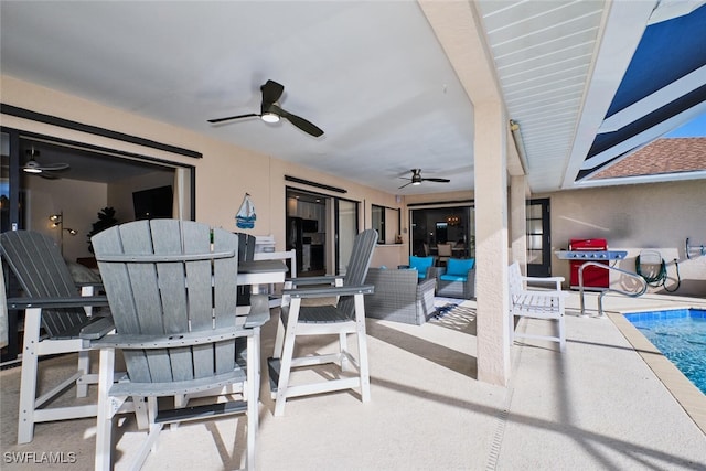 view of patio / terrace with an outdoor living space, an outdoor pool, and a ceiling fan