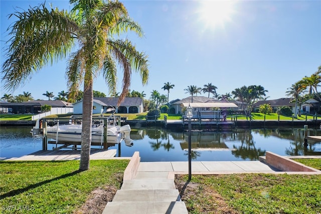 view of dock with a residential view, boat lift, a lawn, and a water view