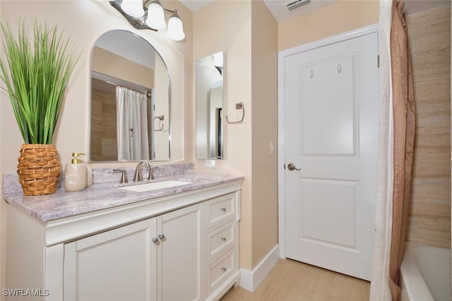 bathroom featuring visible vents, a bathing tub, a shower with curtain, and vanity