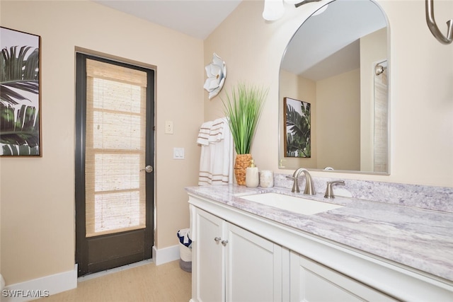 bathroom with baseboards and vanity