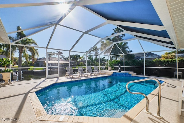 outdoor pool with a patio and a lanai