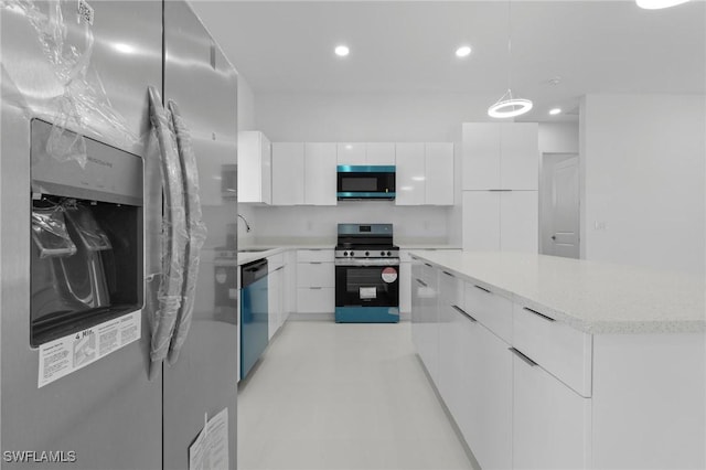 kitchen with a center island, white cabinets, appliances with stainless steel finishes, and modern cabinets