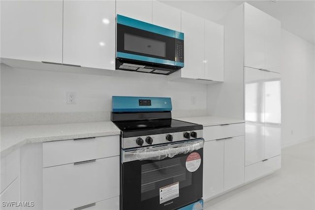 kitchen featuring white cabinetry, electric stove, and modern cabinets