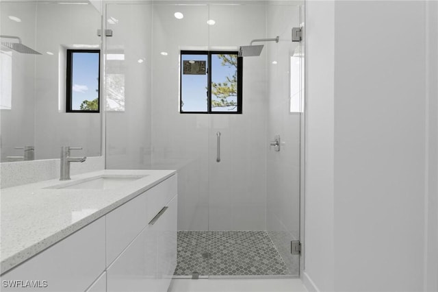 bathroom with a stall shower and vanity