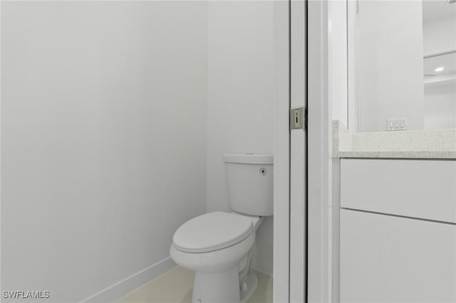 bathroom featuring baseboards and toilet