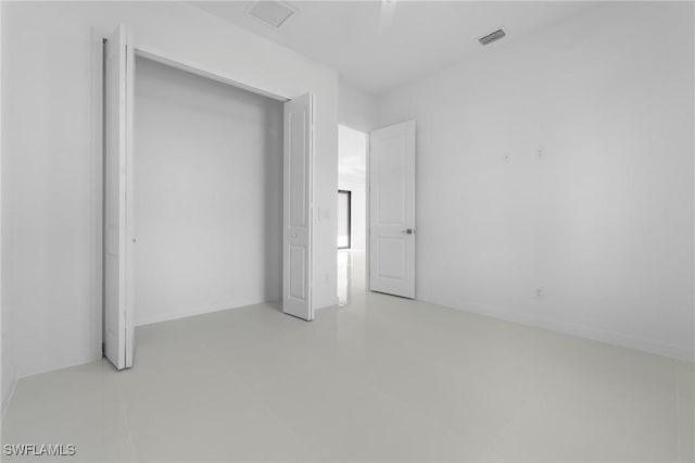 unfurnished bedroom with visible vents and a closet