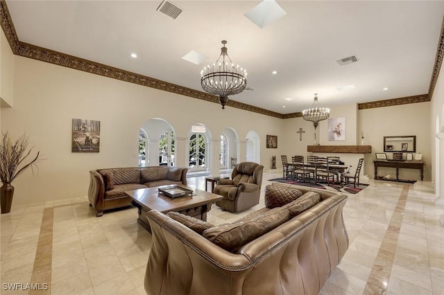 living room featuring arched walkways, a notable chandelier, recessed lighting, and visible vents