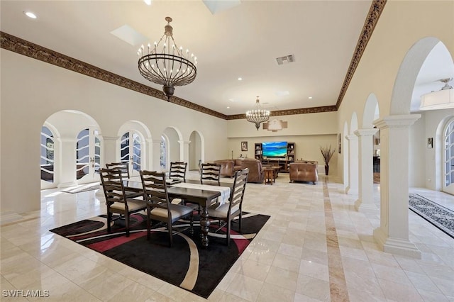 dining space featuring an inviting chandelier, arched walkways, visible vents, and ornate columns