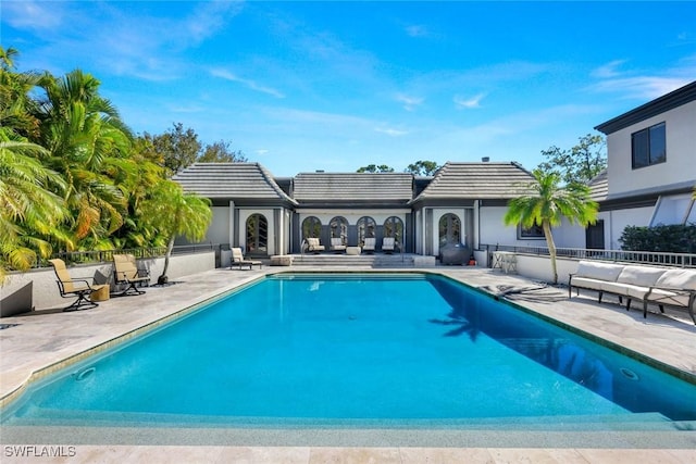 view of swimming pool featuring a fenced in pool, a patio, and fence